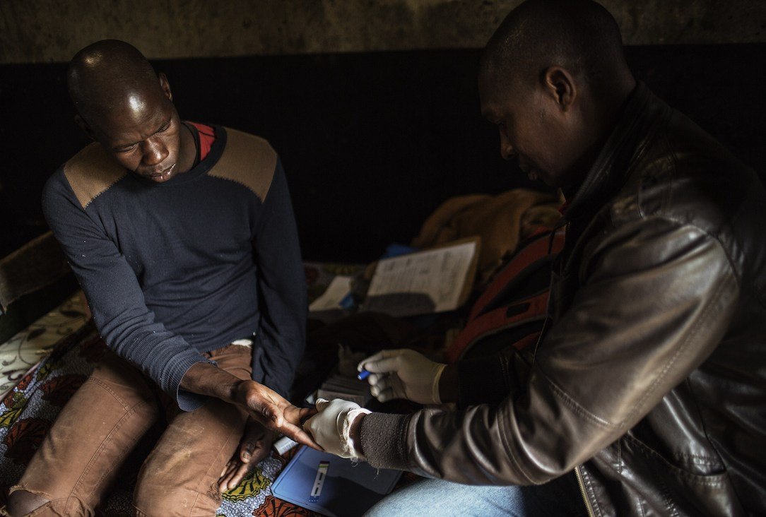 A worker receives an HIV test.
